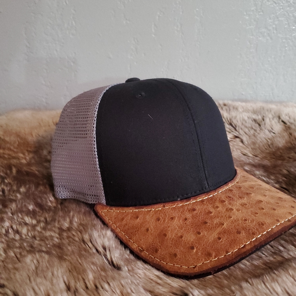 Ball cap with hand-sewn leather patch on brim